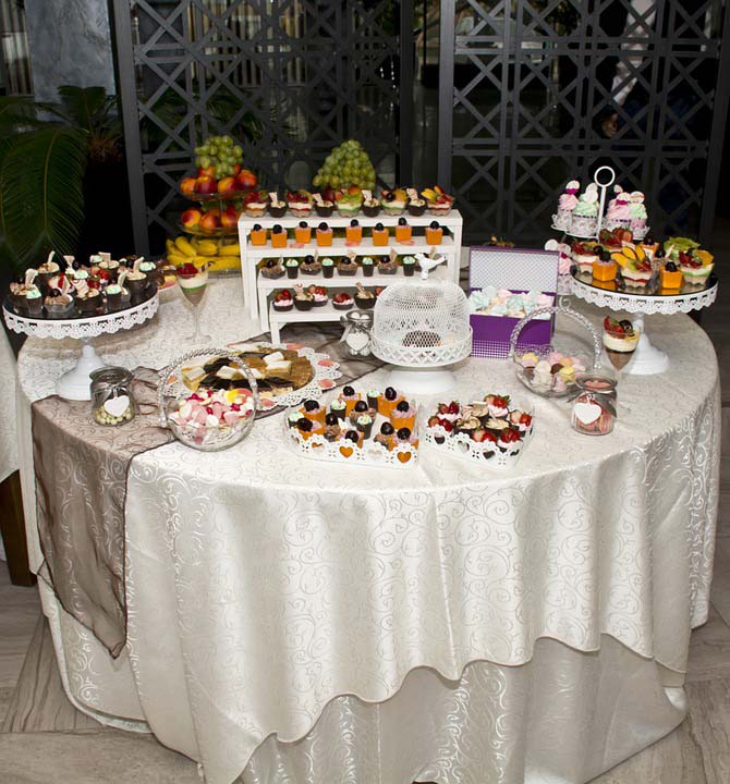 Beautiful wedding self-service table, white cloth, lots of sweets