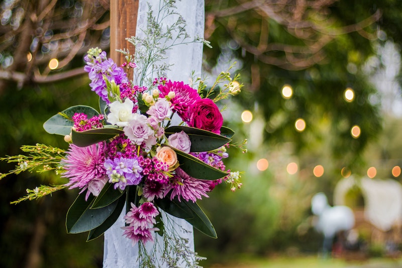 Fuschia pink and orange wedding bouquet in outdoor wedding
