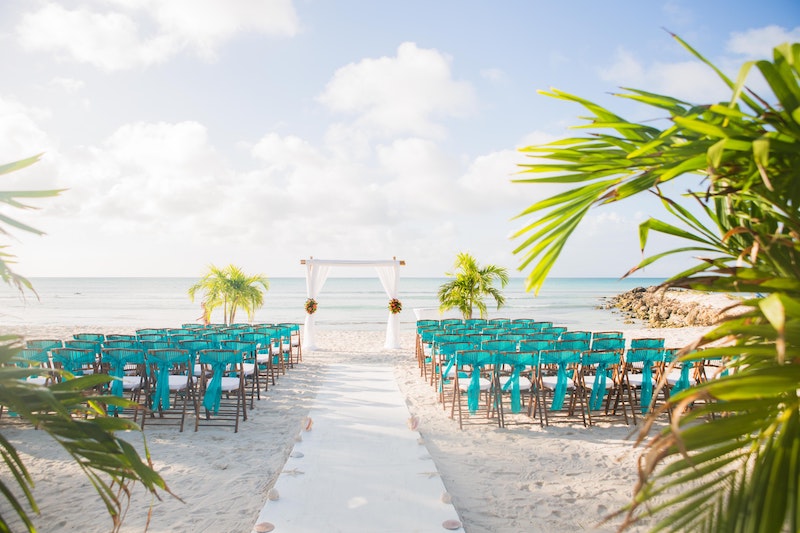 Tropical beach wedding with turquoise chairs