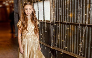 girl in a gold bat mitzvah dress